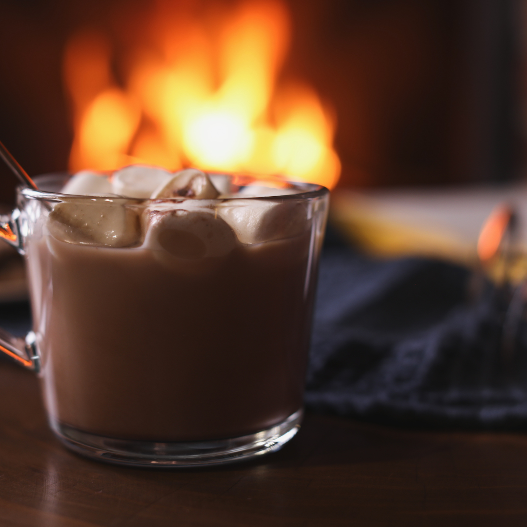 Delicious Sweet Cocoa with Marshmallows and Blurred Fireplace on Background