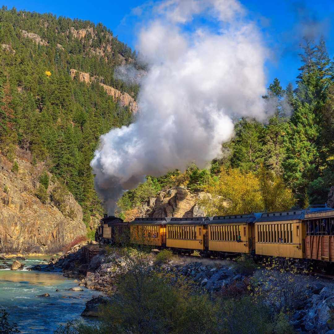 Historic steam engine train from Durango to Silverton through the San Juan Mountains along the river in Colorado, USA