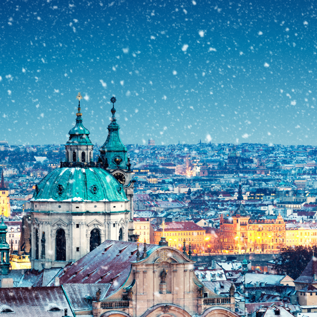 The Cathedral of Saint Nicholas in Prague on snowy Christmas evening 