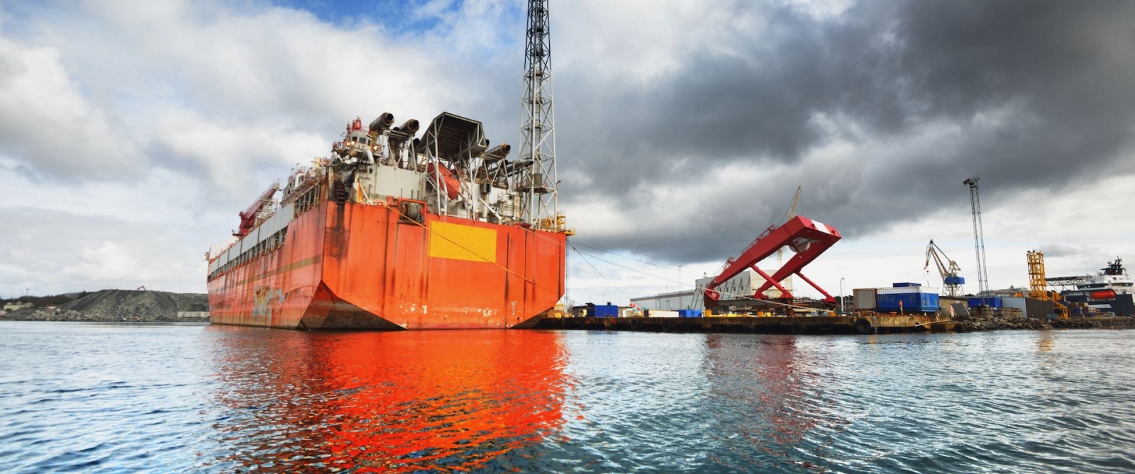 Floating, production, storage and offloading FPSO vessel moored to the shore in a port, close-up. Riga, Latvia
