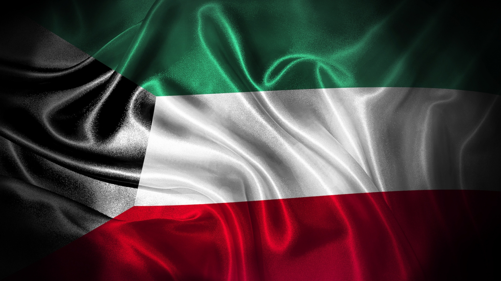 Закройте вверх, размахивая флагом Кувейта.  Национальный флаг Кувейта