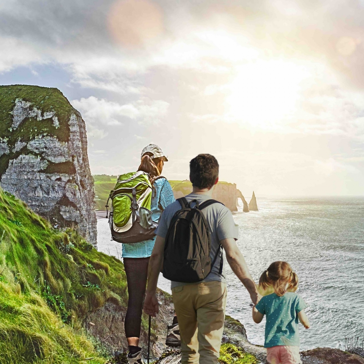 A family on a hiking trail in Normandy close to Le Havre enjoys the beautiful sunset