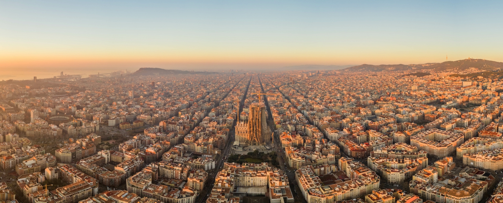 Aerial panorama drone shot of Barcelona city church in construction in sunrise hour in Spain winter 