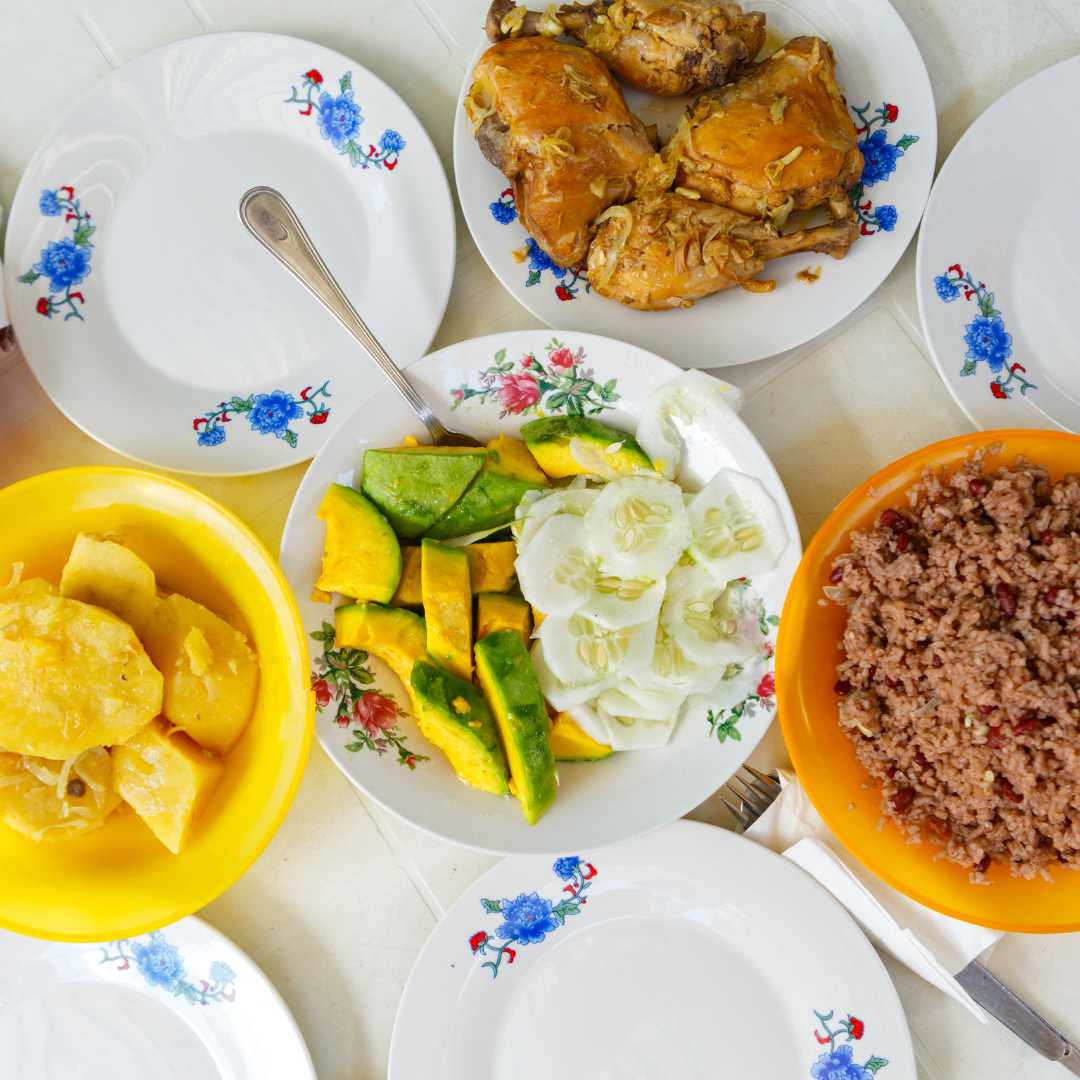 Typical Cuban meal consisting of beans and rice, avocado and chicken