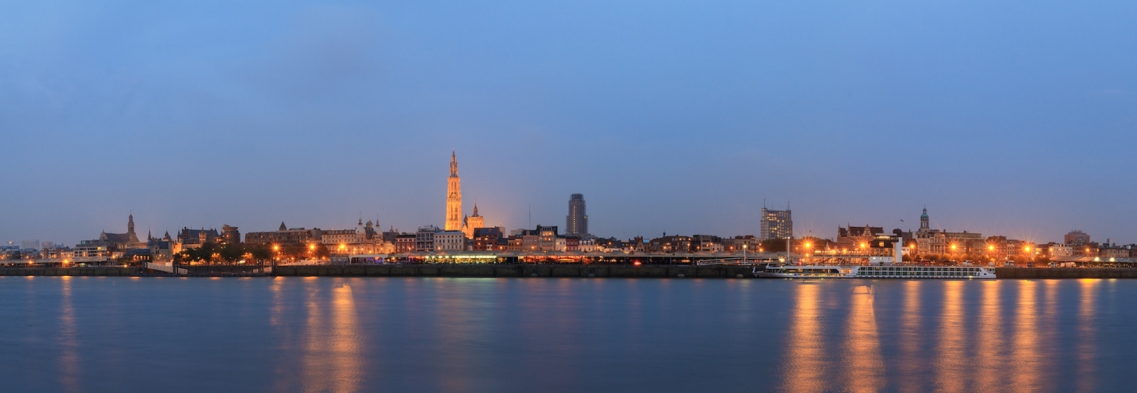 Bellissimo panorama urbano dello skyline di Anversa, in Belgio, durante l'ora blu vista dalla riva del fiume Schelda