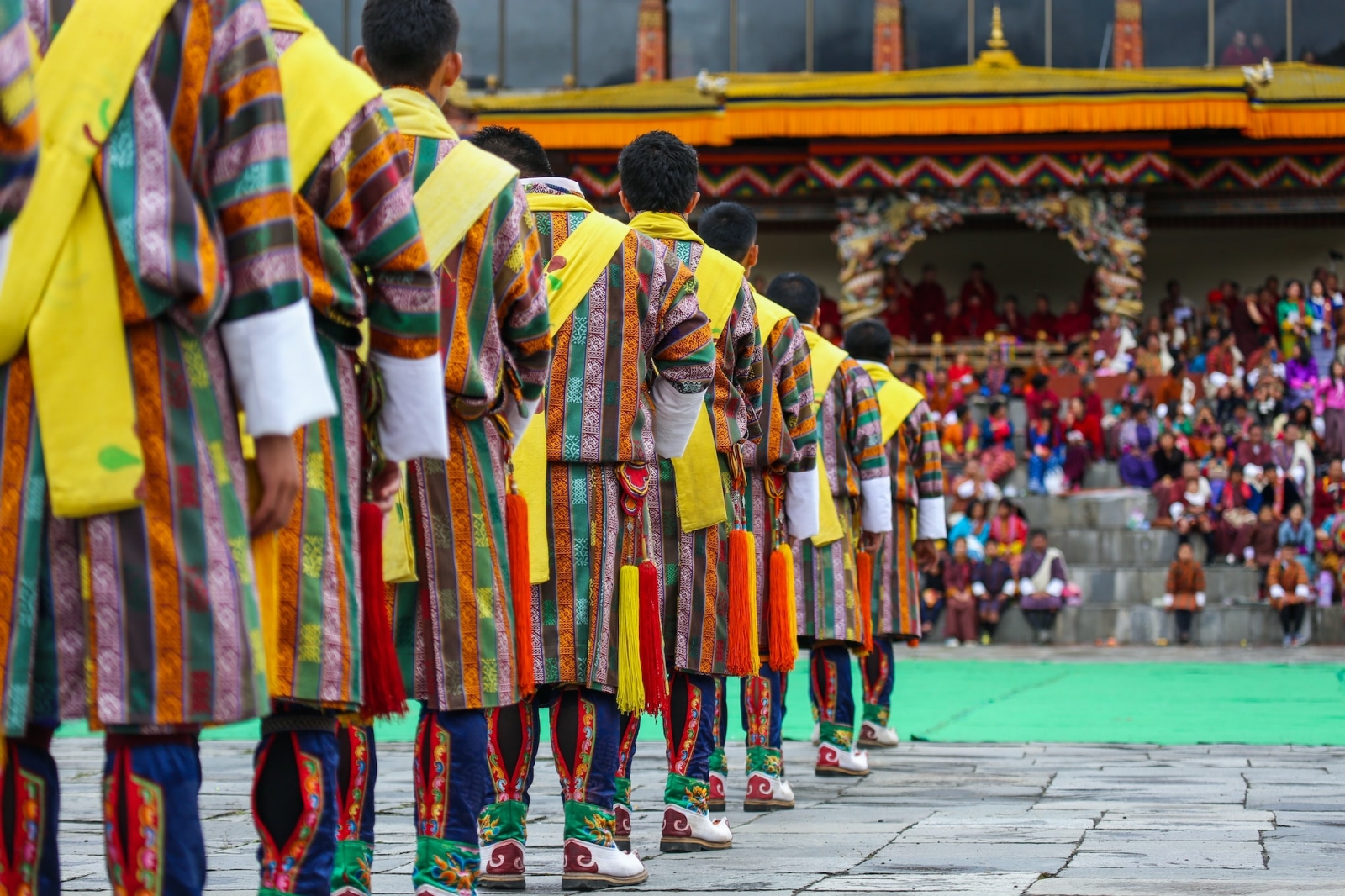 A group of male dancers get ready for a traditional performance during Thimphu Tshechu (festival).