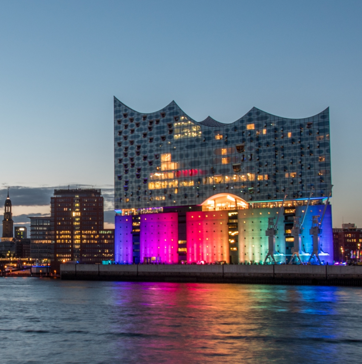 Hamburg, Germany, Panorama of the Harbour at night. With the colored illuminated music hall at Christopher Street Day