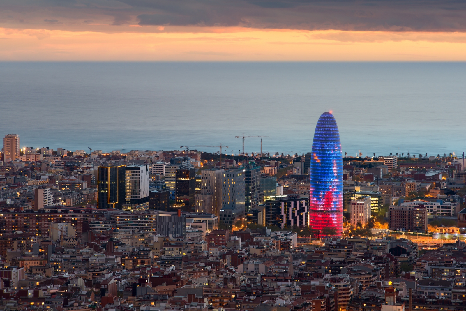Scenic aerial view of Barcelona city skyscraper and skyline at night in Barcelona, Spain.