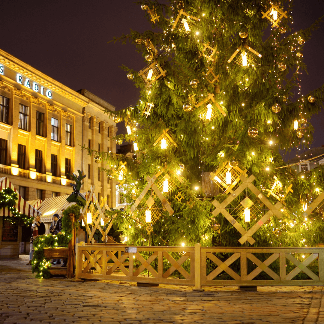 RIGA, LETTONIA - DICEMBRE - Persone che si godono il mercatino di Natale più autentico di Riga che offre decine di bancarelle di artigianato e cibo, oltre a un gigantesco albero di Natale