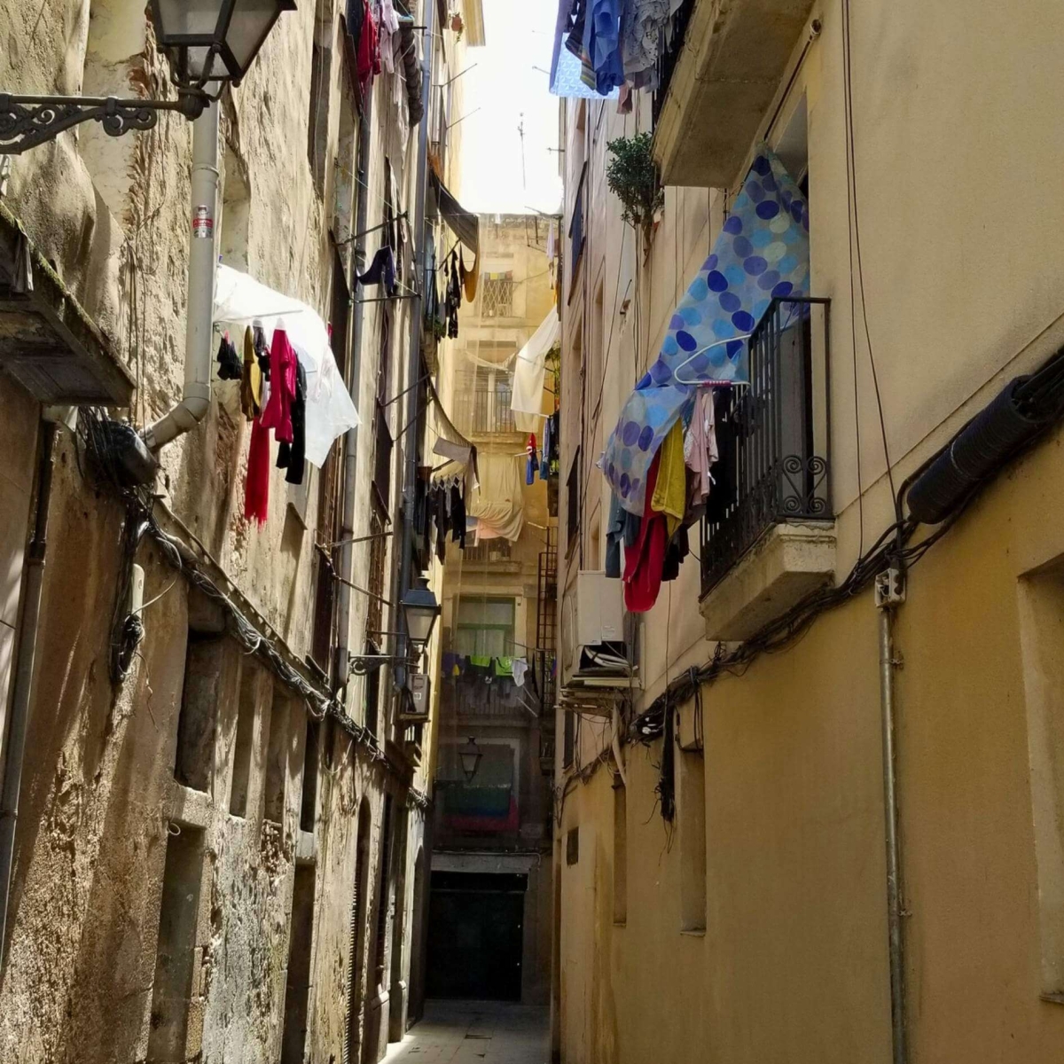 A narrow street in Barcelona, porches with laundry drying