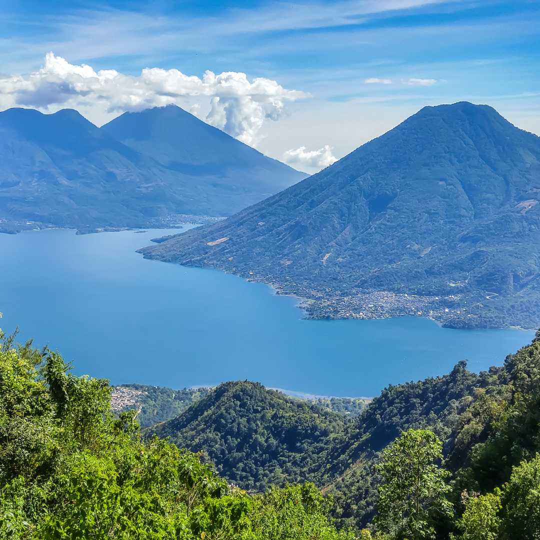 San Marcos La Laguna area, Guatemala. View of surrounding volcanoes with tranquil Lake Atitlán in foreground